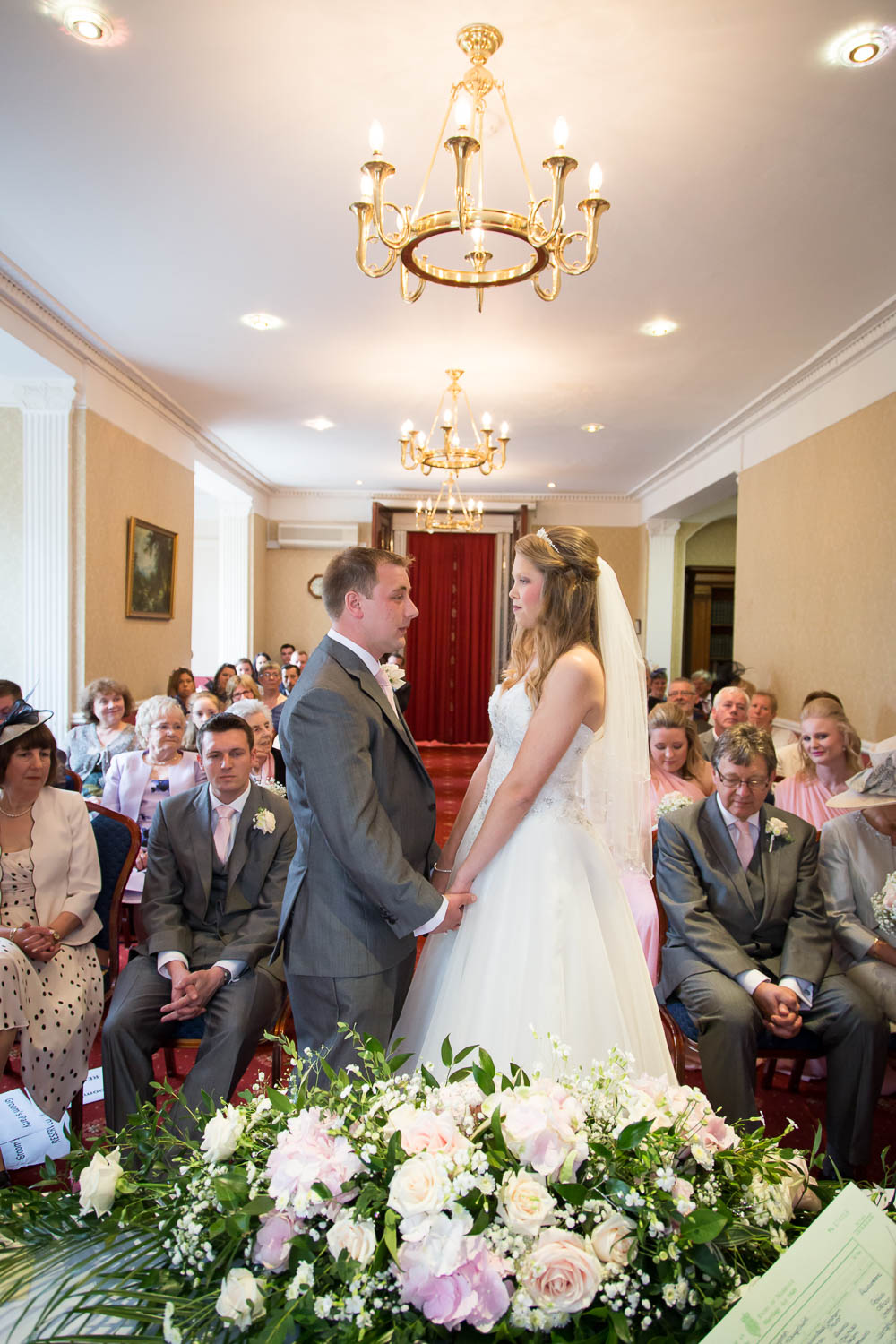 Bride and groom exchange vows in elegant wedding ceremony by Southampton wedding photographer John Watson