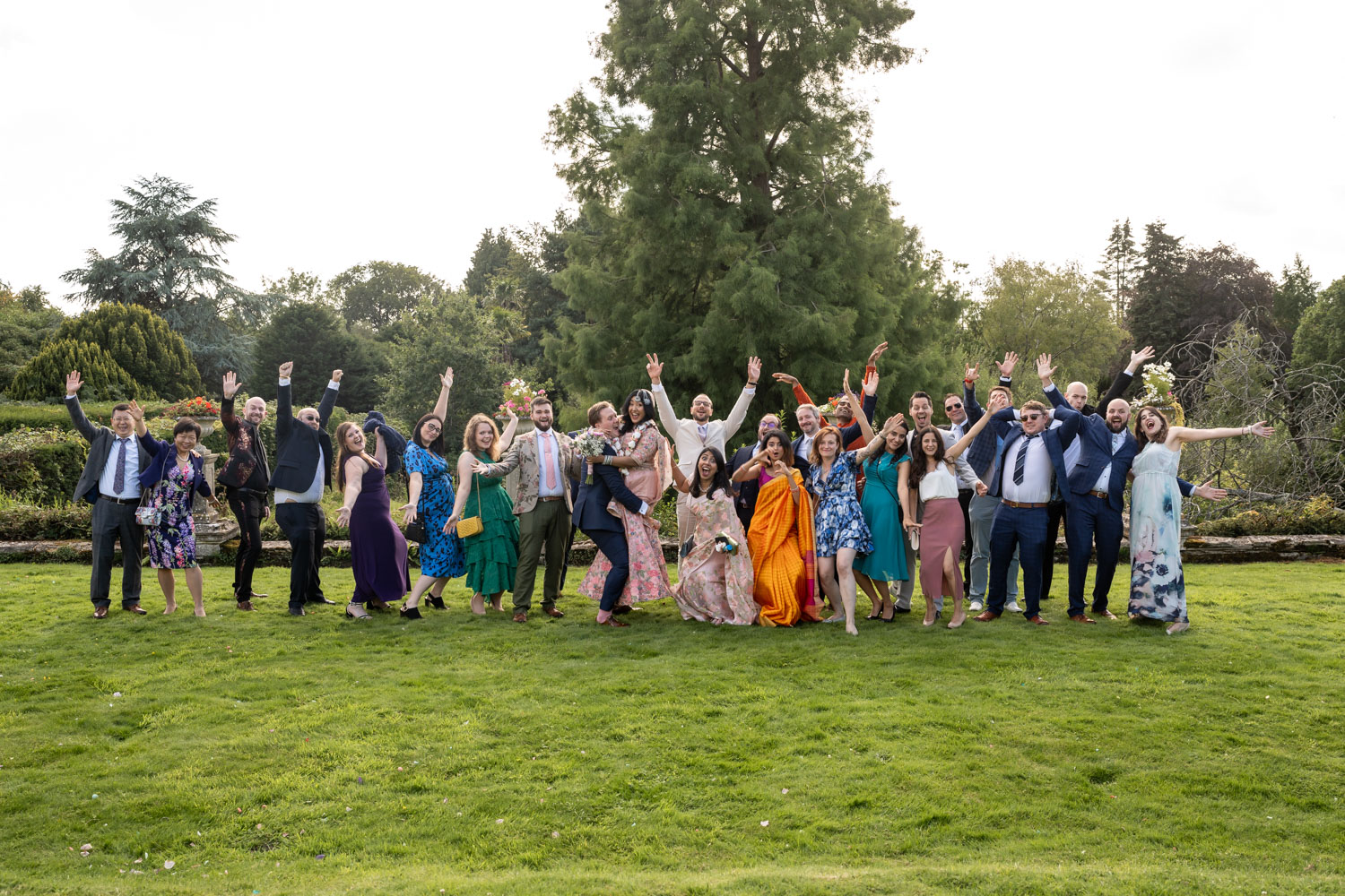 Group of wedding guests celebrating outdoors by Southampton wedding photographer John Watson