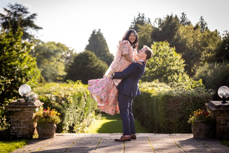 Couple celebrating in a garden by Southampton wedding photographer John Watson