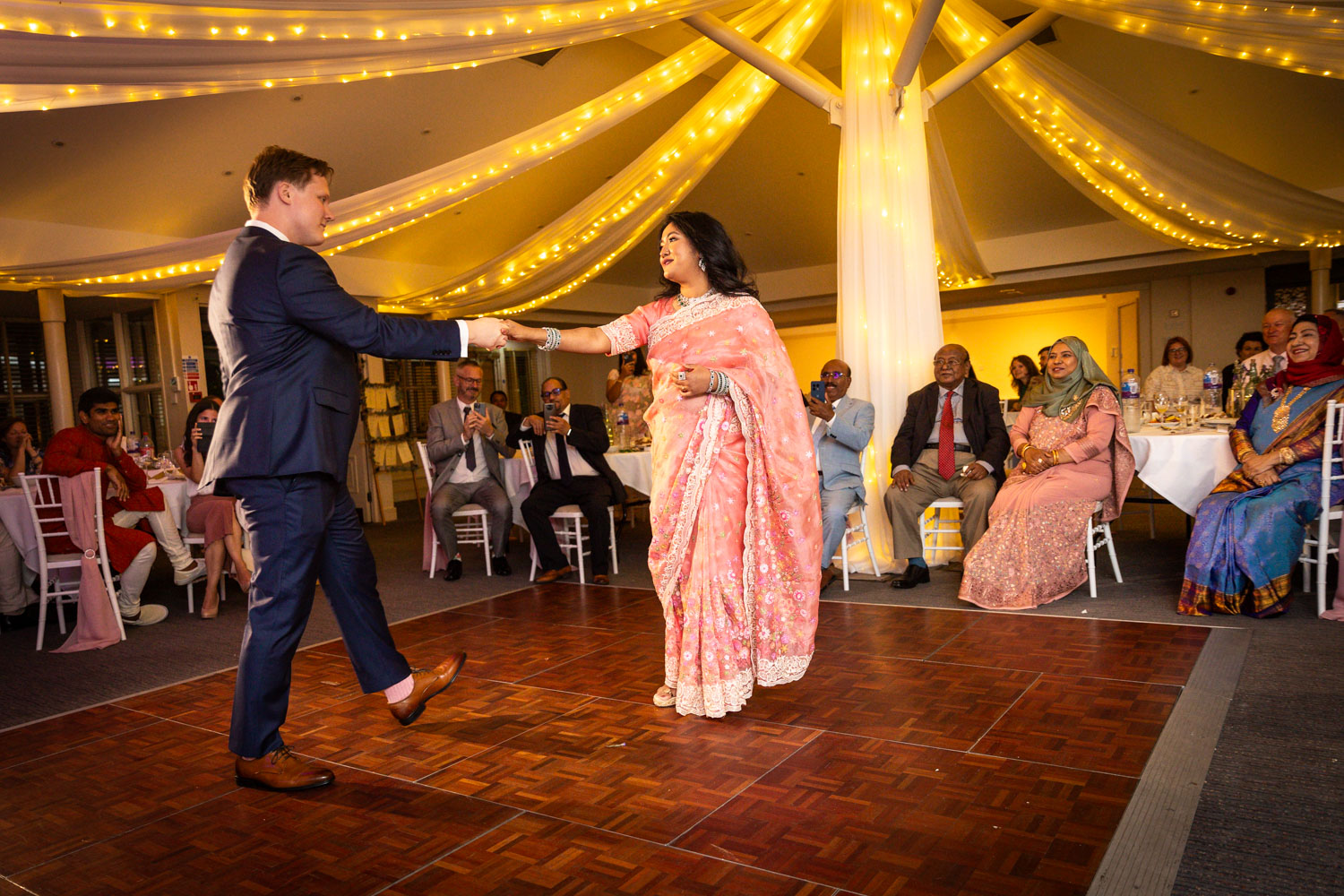 Bride and groom dancing at vibrant wedding by Southampton wedding photographer John Watson