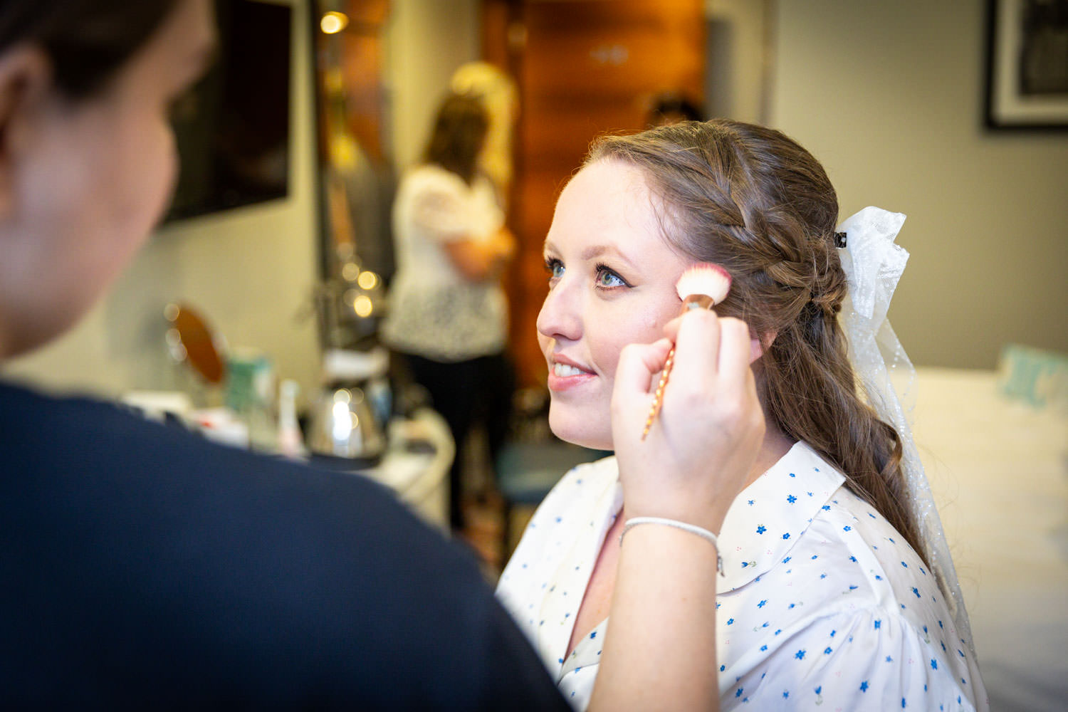 Bride getting makeup on wedding day by Southampton wedding photographer John Watson