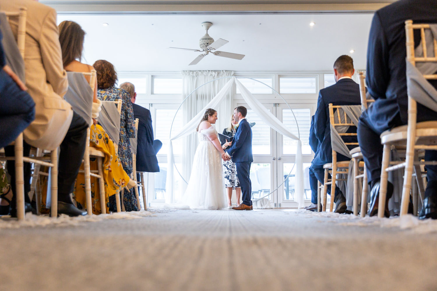 Bride and groom exchanging vows indoor ceremony by Southampton wedding photographer John Watson