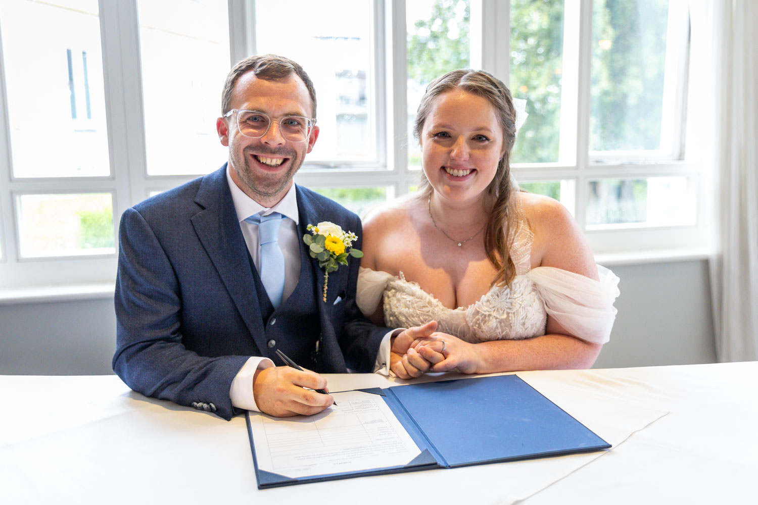 Bride and groom signing marriage certificate by Southampton wedding photographer John Watson