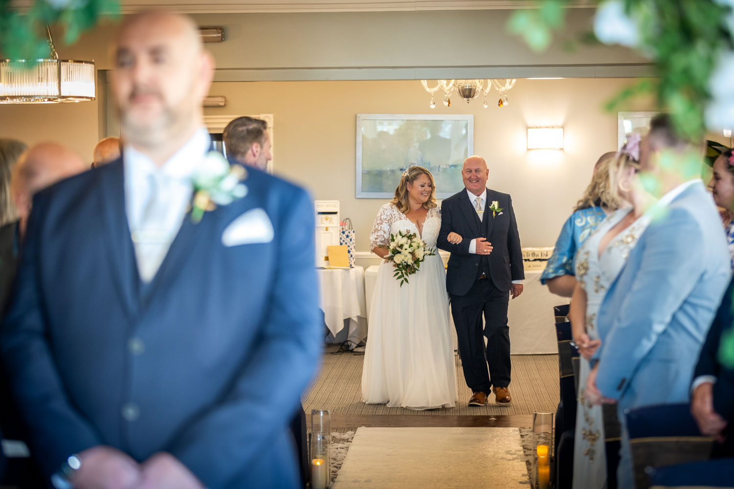 Bride walking down the aisle with her father by Southampton wedding photographer John Watson
