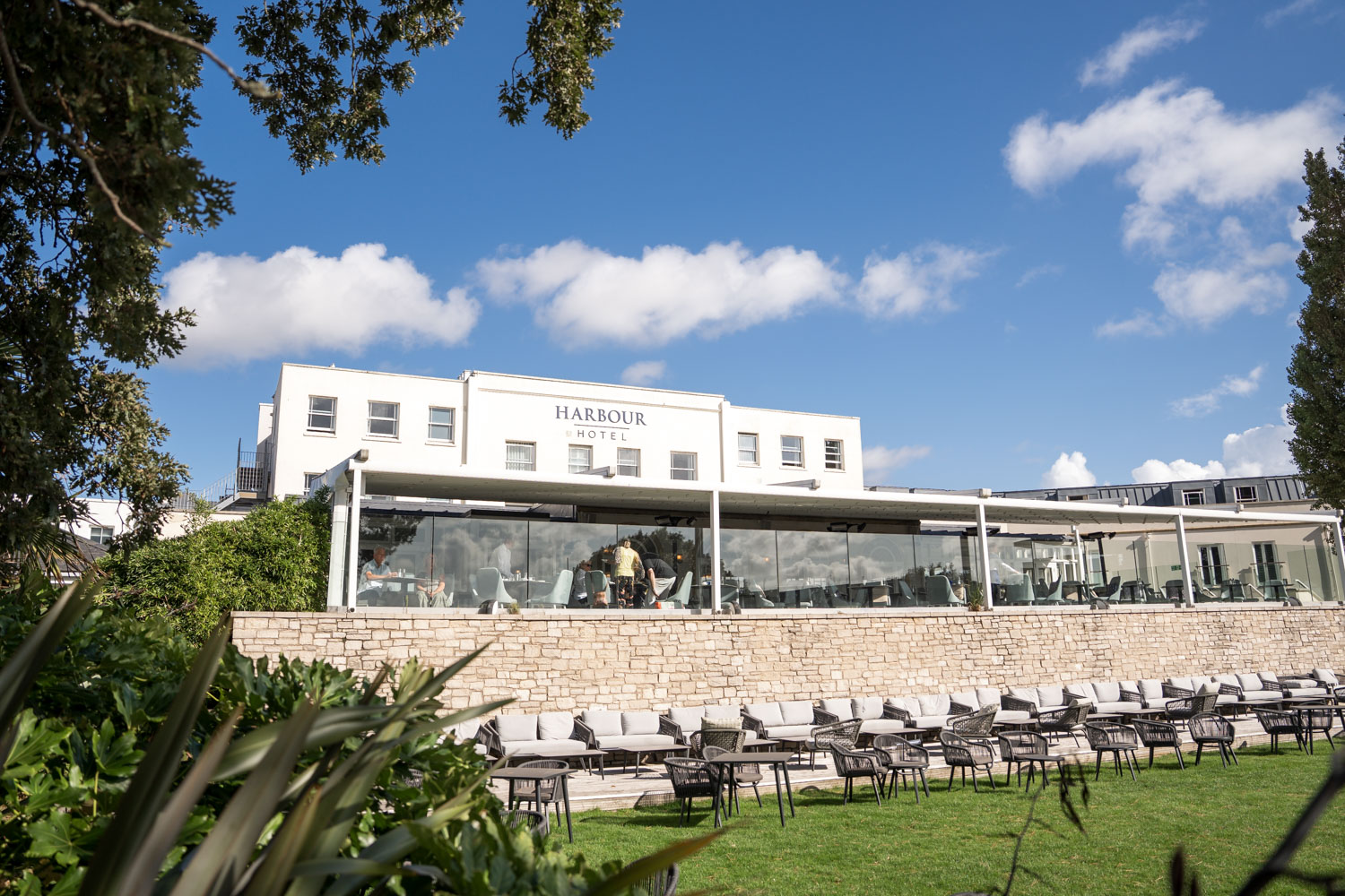 White building with glass terrace on sunny day by Southampton wedding photographer John Watson