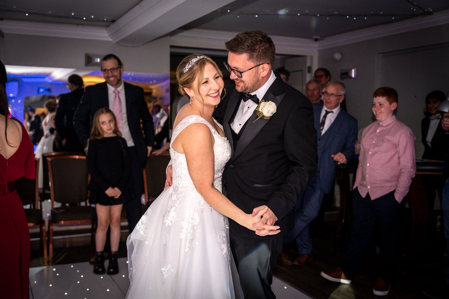 Bride and groom dancing joyfully at wedding reception by Southampton wedding photographer John Watson