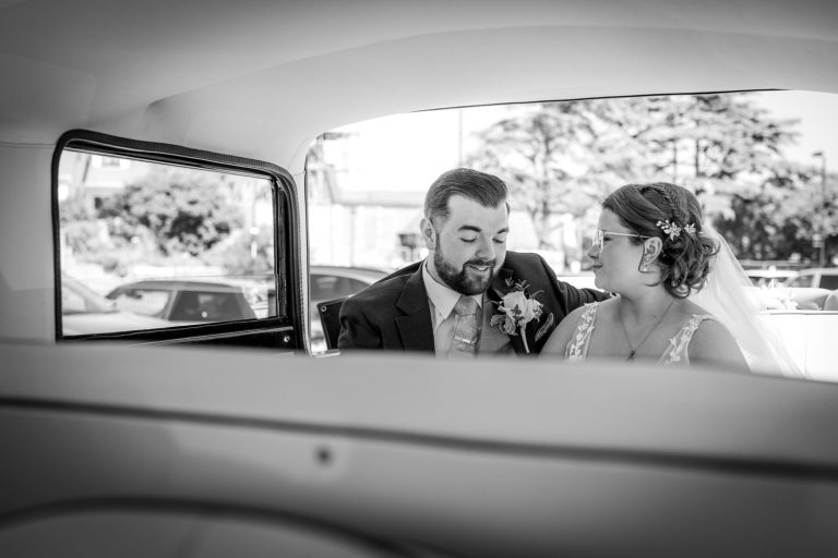 Bride and groom in wedding car by Southampton wedding photographer John Watson