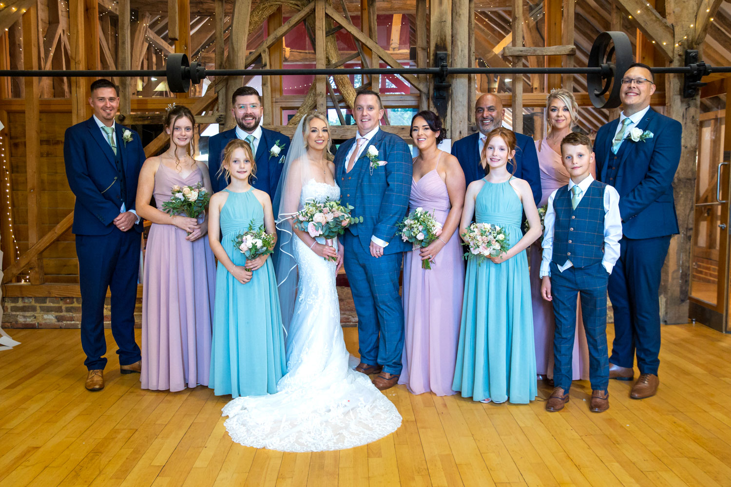Wedding party in rustic barn setting by Southampton wedding photographer John Watson