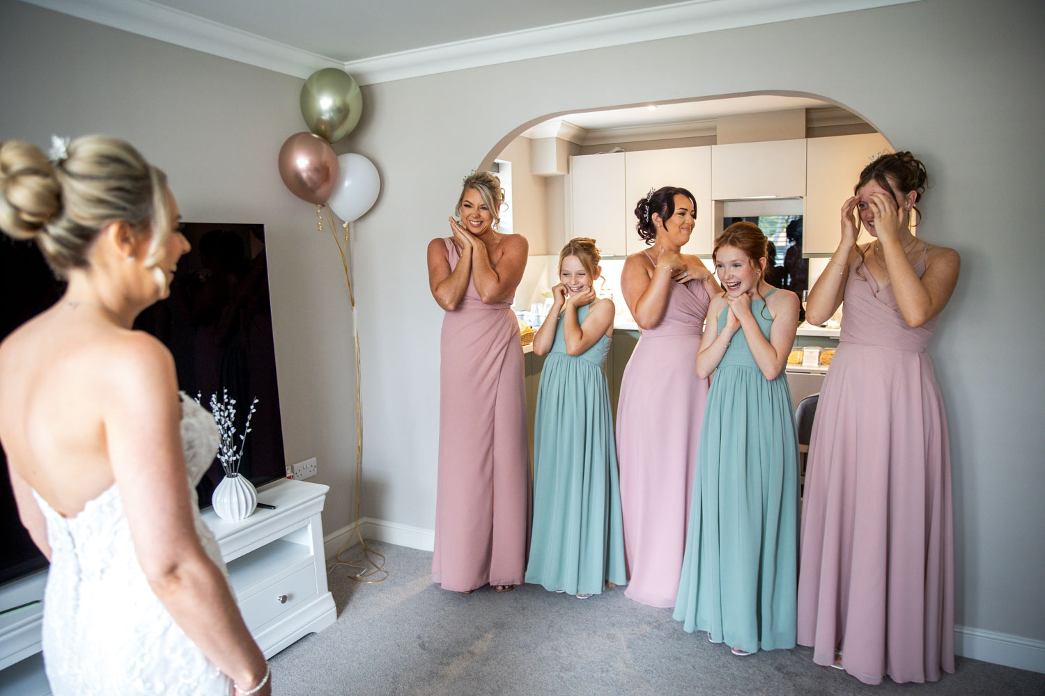 Bridesmaids react happily to bride's arrival by Southampton wedding photographer John Watson