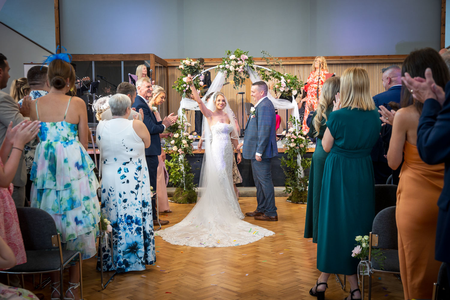 Bride and groom at ceremony with guests by Southampton wedding photographer John Watson