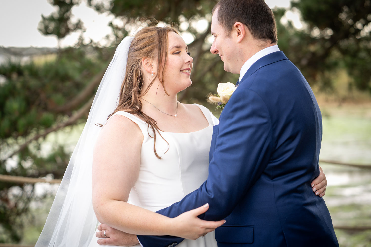 Smiling newlyweds embracing on their wedding day by Southampton wedding photographer John Watson