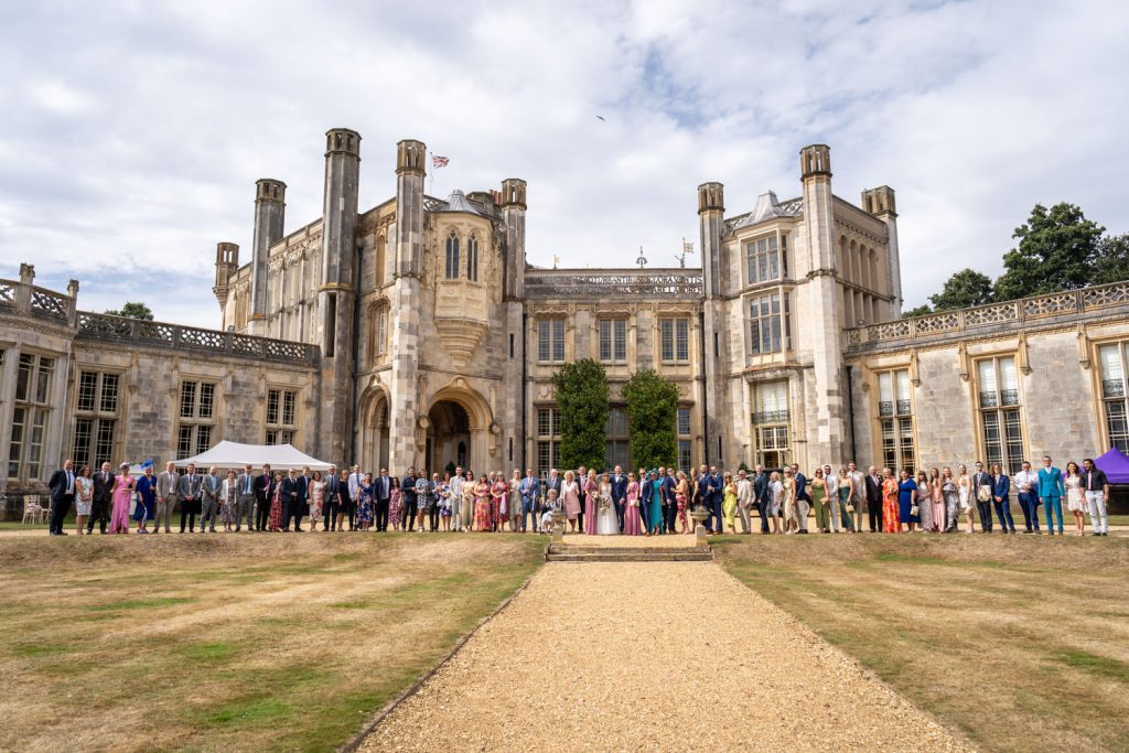 Wedding guests gathered at a historic venue by Southampton wedding photographer John Watson