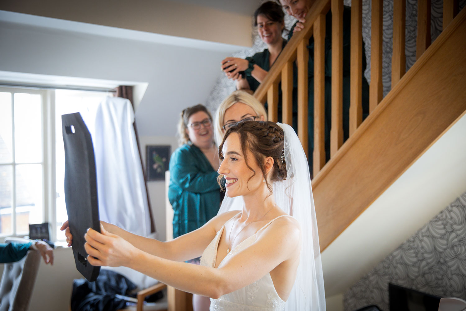 Bride getting ready with friends on wedding day by Southampton wedding photographer John Watson