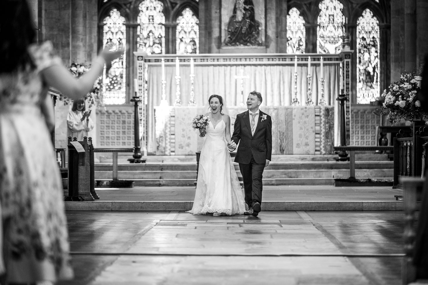 Bride and groom walking down church aisle by Southampton wedding photographer John Watson