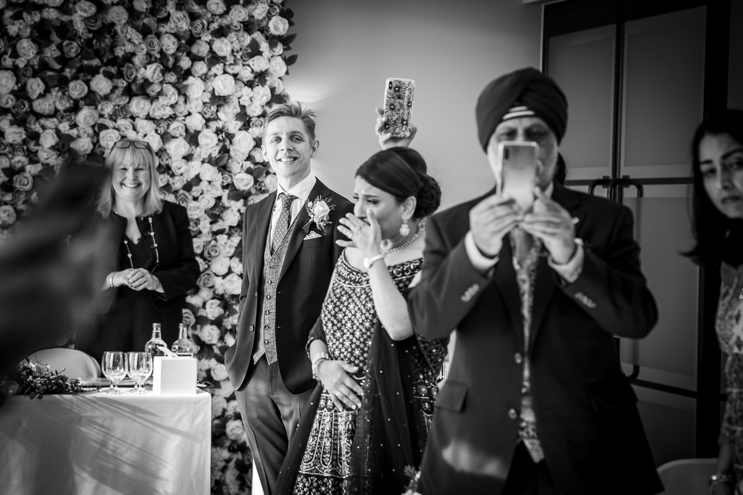 Happy wedding guests capturing memorable moments by Southampton wedding photographer John Watson