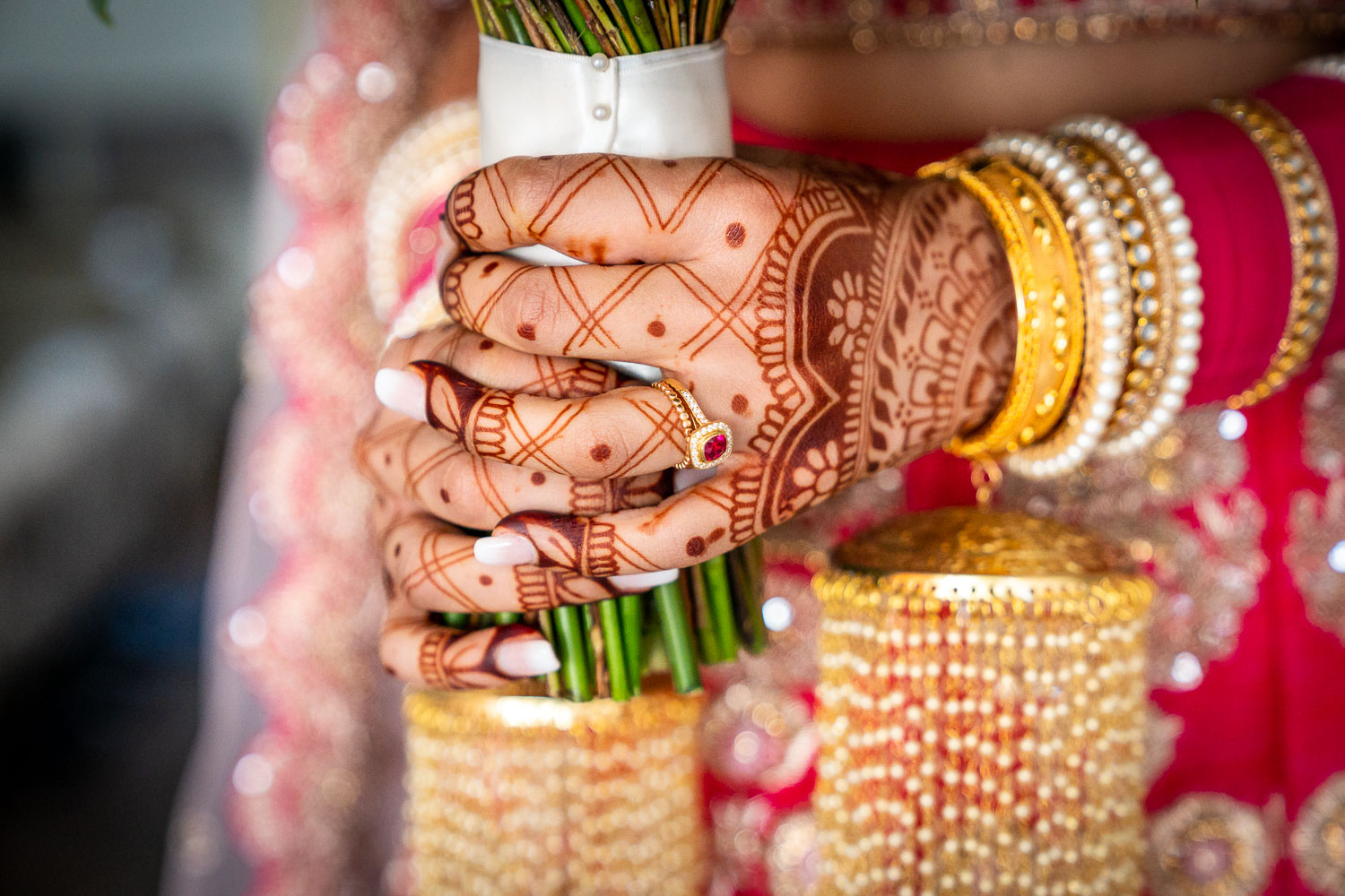 Bridal henna with gold jewellery and flowers by Southampton wedding photographer John Watson