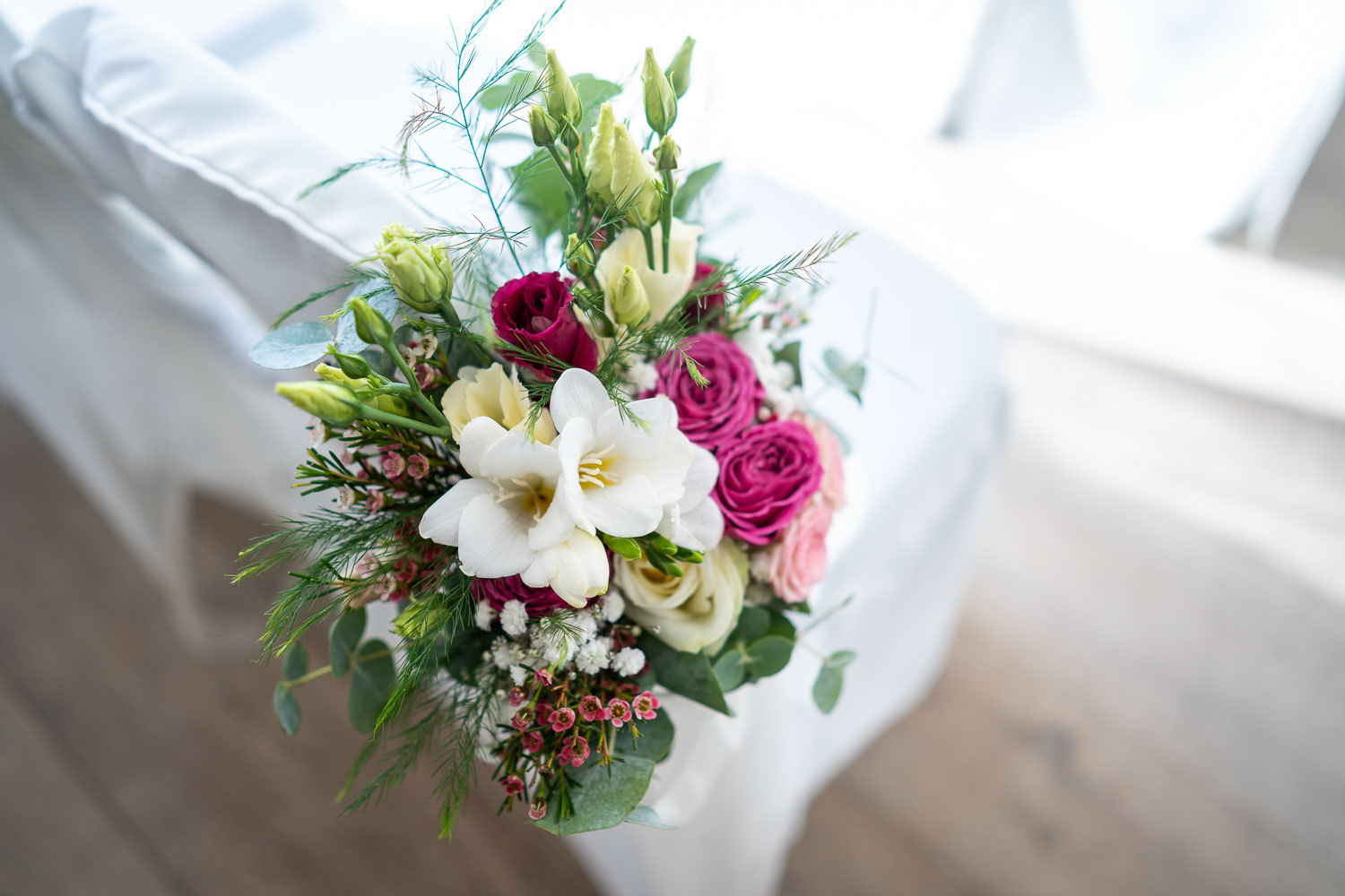Elegant wedding bouquet with white lilies by Southampton wedding photographer John Watson