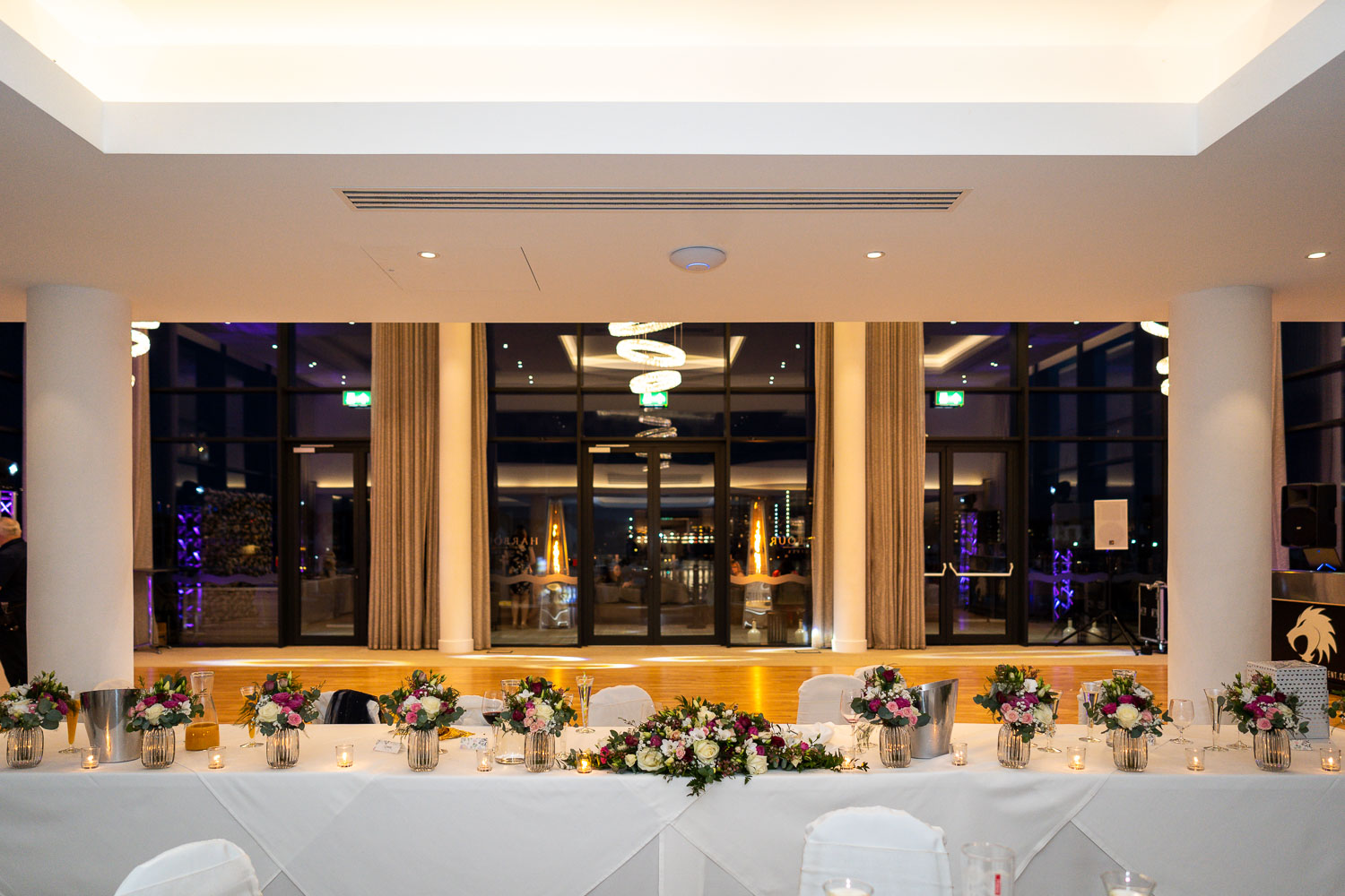 Elegant wedding reception setup with floral centrepieces by Southampton wedding photographer John Watson