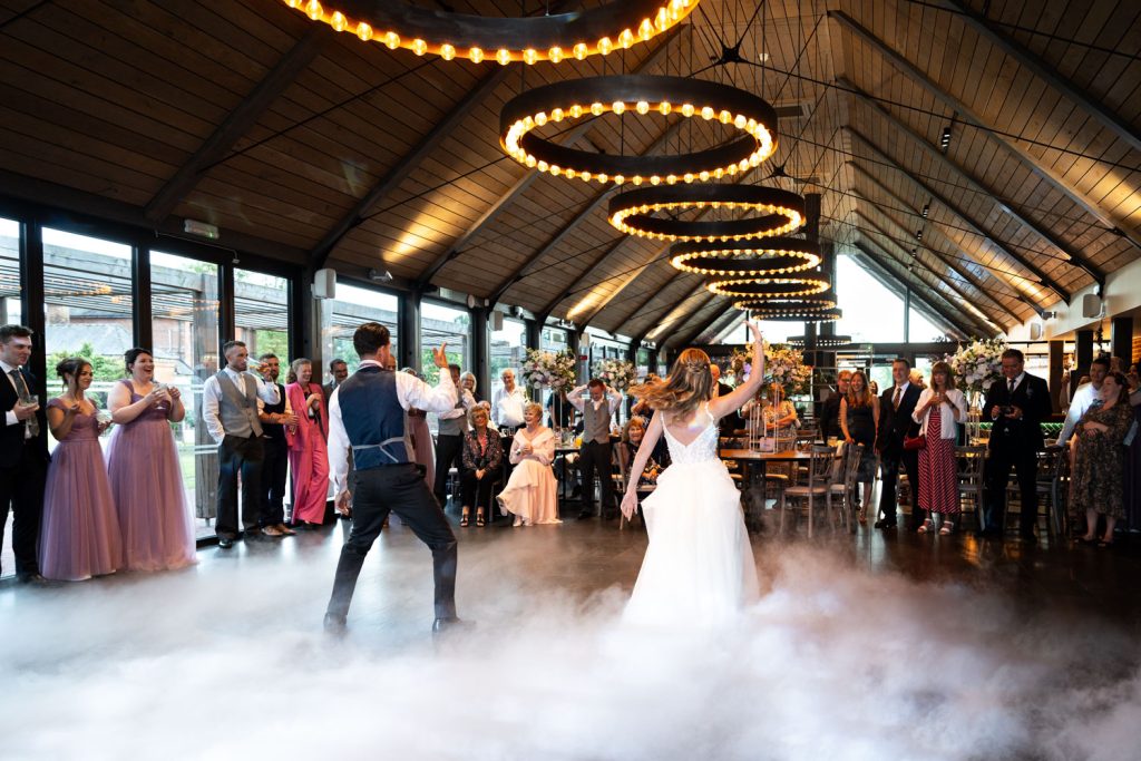 Bride and groom dancing at wedding reception by Southampton wedding photographer John Watson