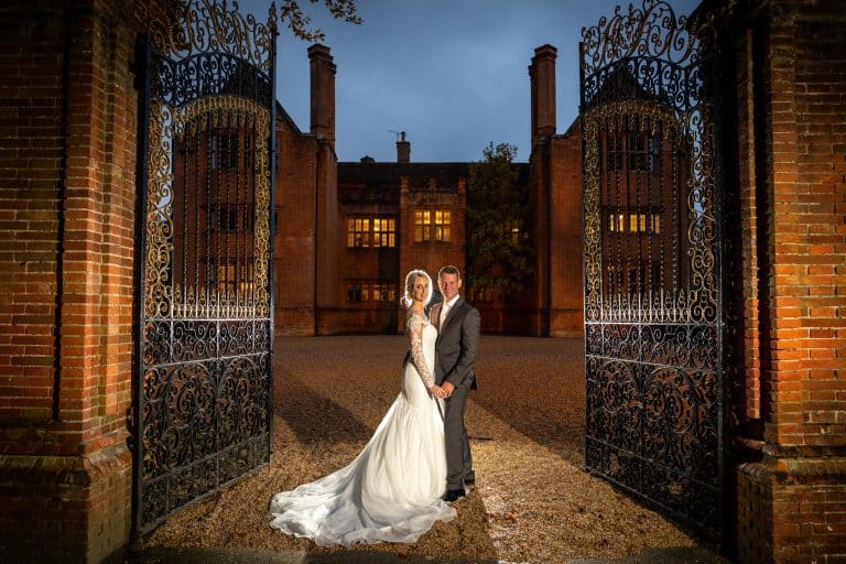 Elegant wedding couple in front of estate by Southampton wedding photographer John Watson