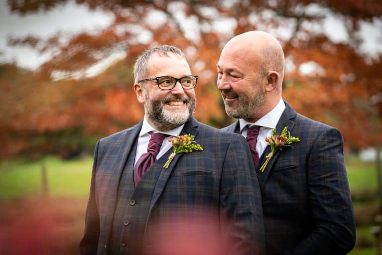 Happy couple celebrating autumn wedding day by Southampton wedding photographer John Watson
