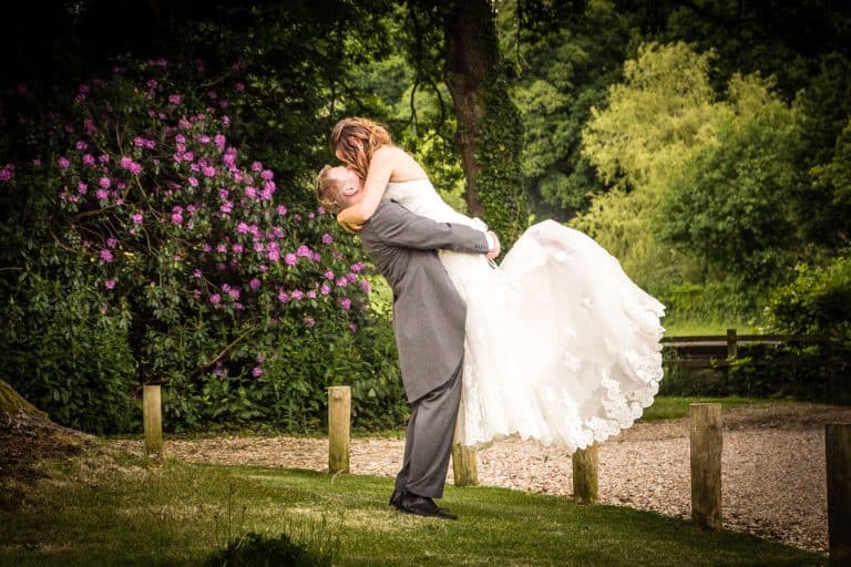 Bride and groom in romantic embrace in garden by Southampton wedding photographer John Watson