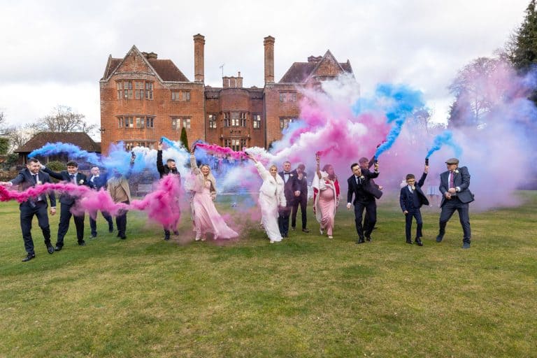Festive wedding celebration with smoke in garden setting by Southampton wedding photographer John Watson