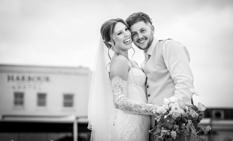 Happy couple posing in black and white by Southampton wedding photographer John Watson