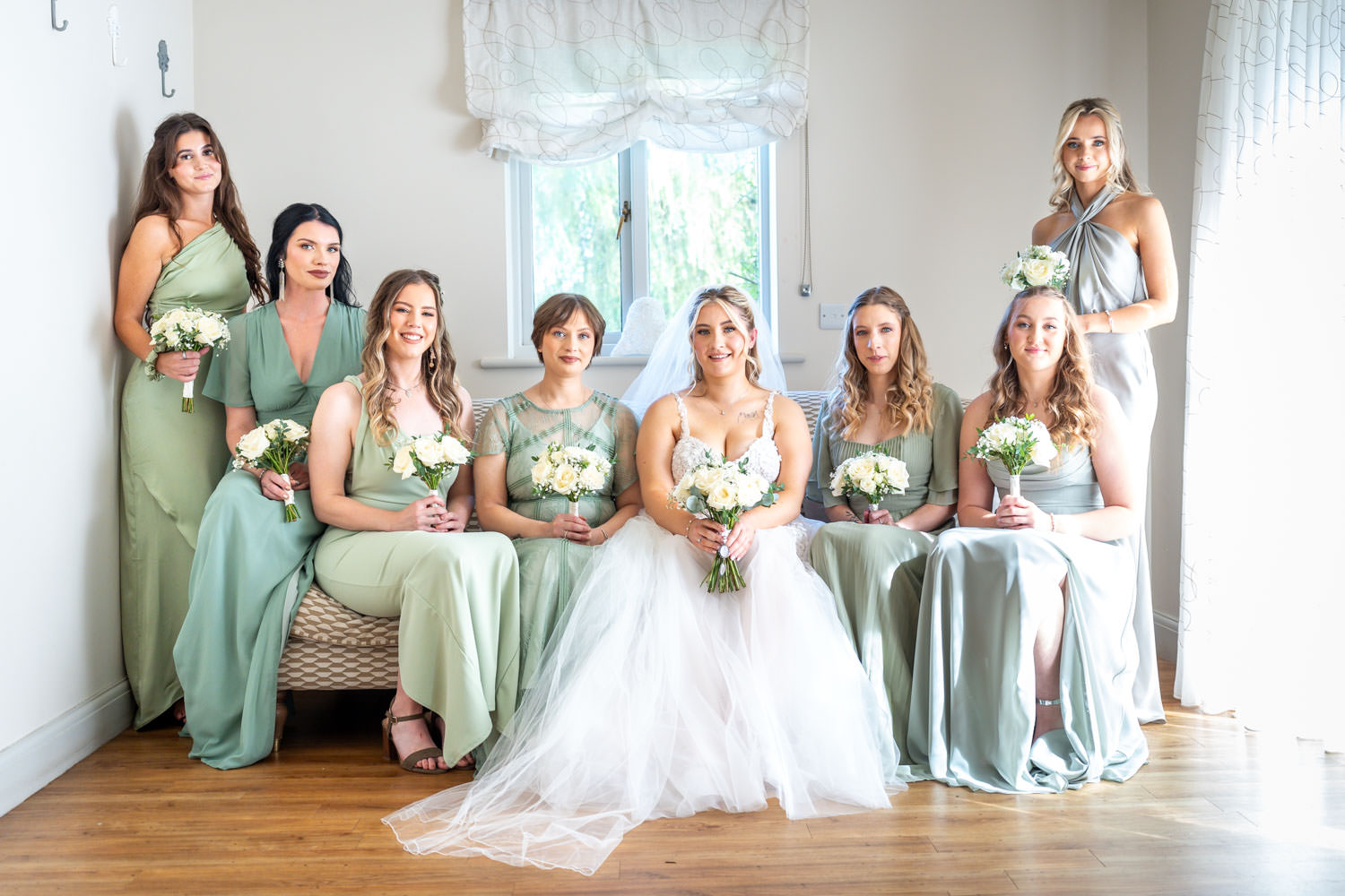 Bridal party portrait in elegant dresses by Southampton wedding photographer John Watson