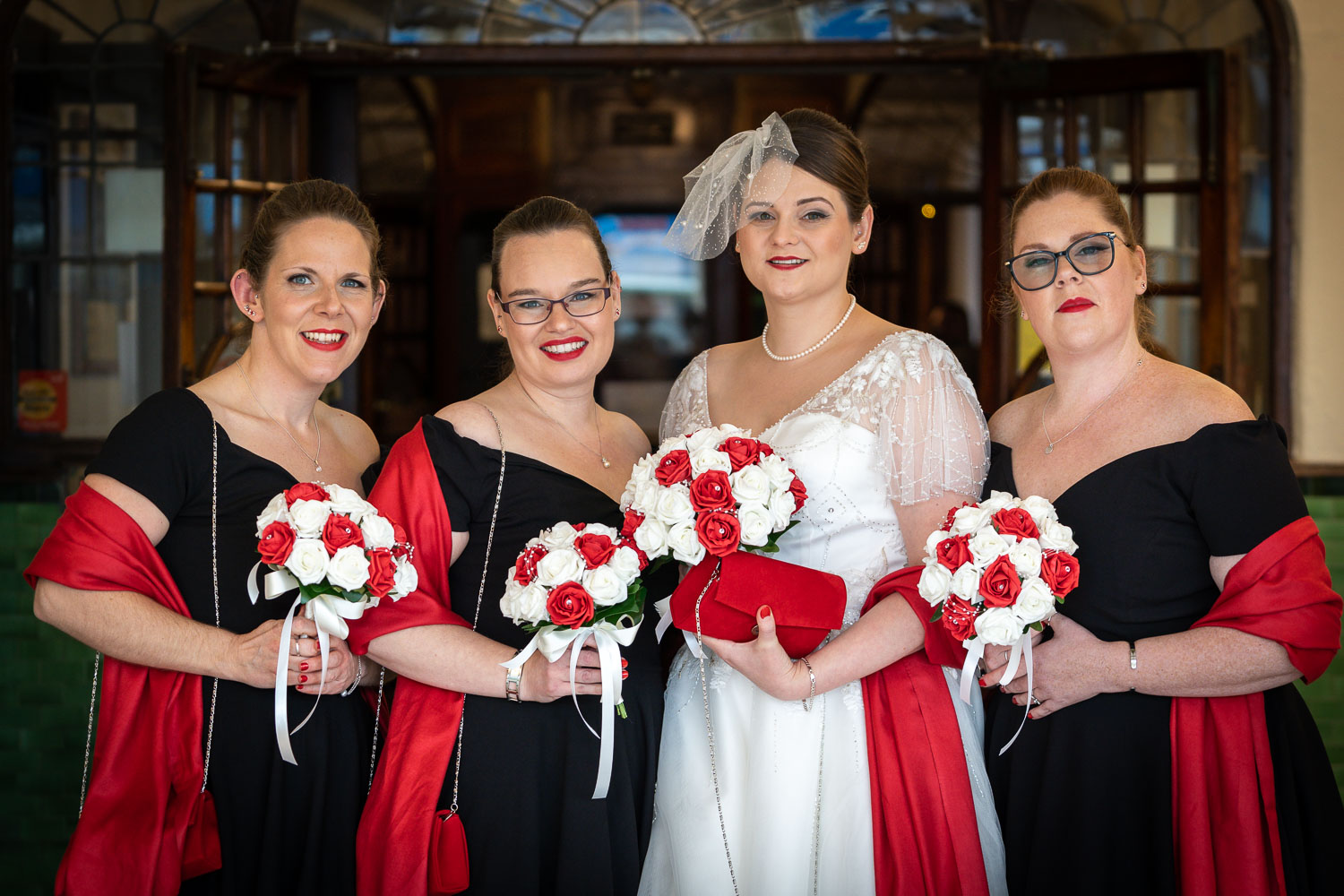 Bride with bridesmaids holding bouquets by Southampton wedding photographer John Watson