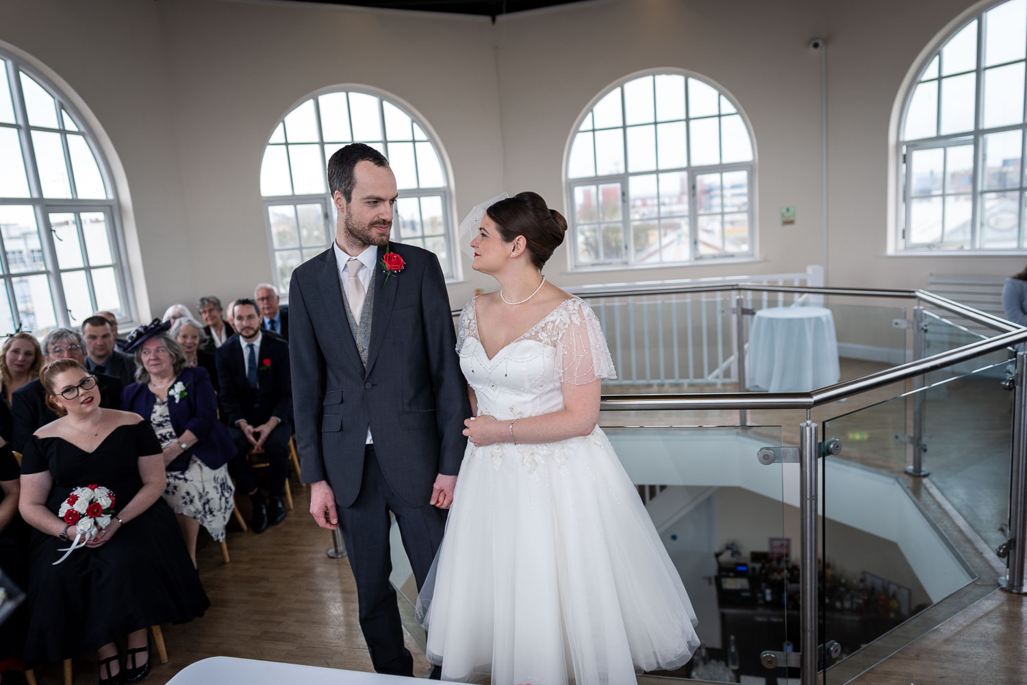 Bride and groom exchange vows in elegant venue by Southampton wedding photographer John Watson