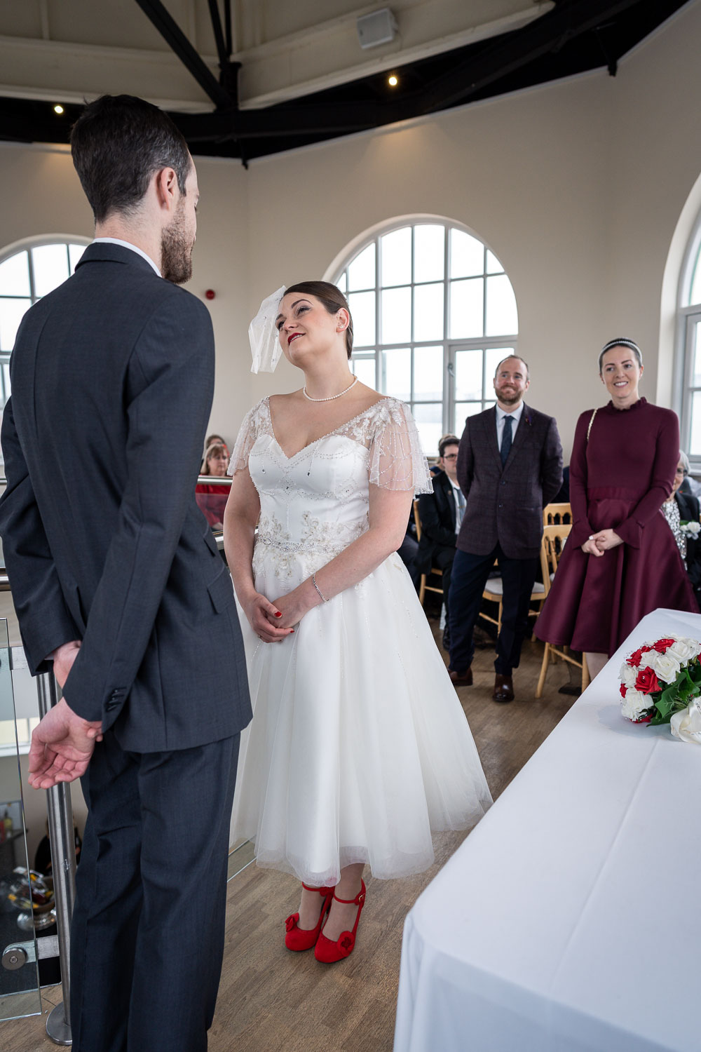 Bride and groom exchanging vows during ceremony by Southampton wedding photographer John Watson