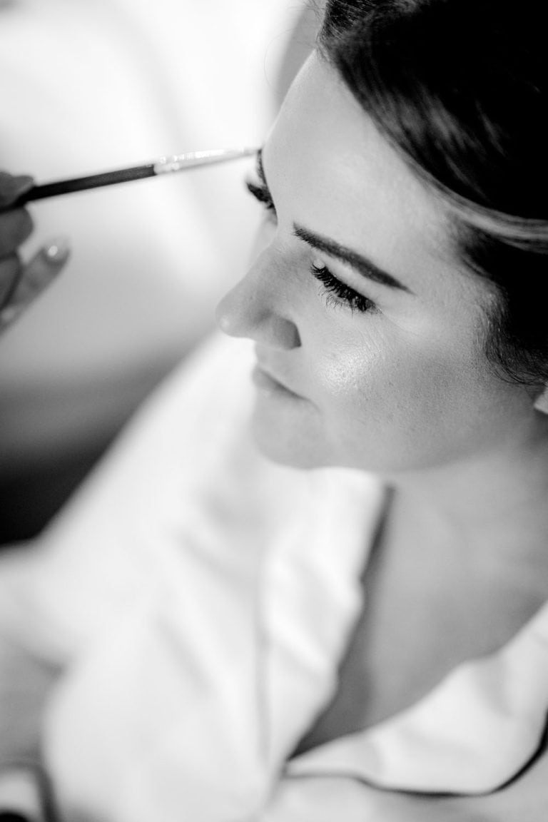 Bride getting makeup done close-up by Southampton wedding photographer John Watson