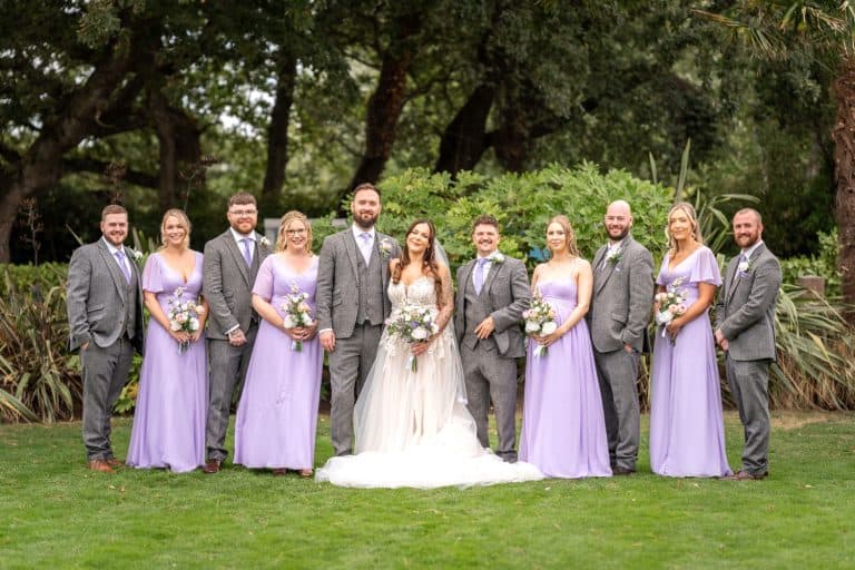 Bridal party in lavender dresses outdoors by Southampton wedding photographer John Watson