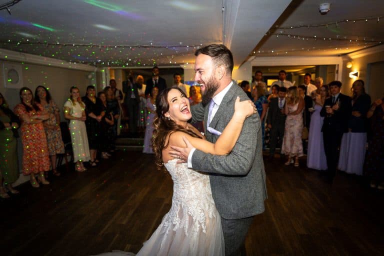 Bride and groom dancing at wedding reception by Southampton wedding photographer John Watson