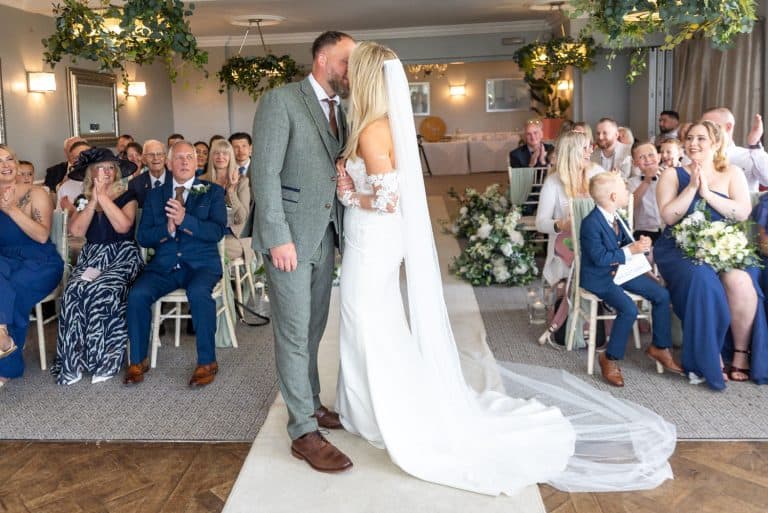Bride and groom kiss during wedding ceremony by Southampton wedding photographer John Watson