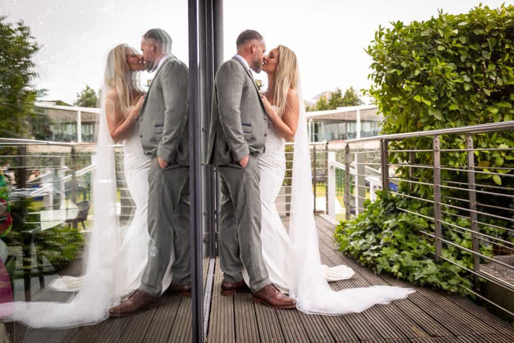 Elegant wedding couple sharing a romantic moment by Southampton wedding photographer John Watson