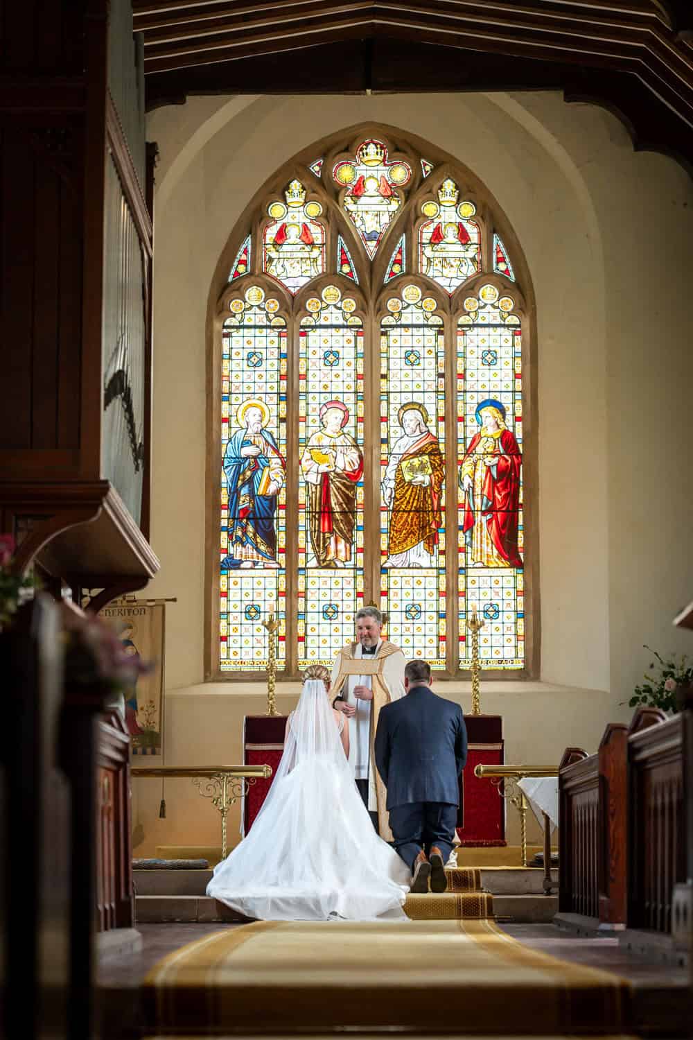 Bride and groom at altar in beautiful church setting by Southampton wedding photographer John Watson