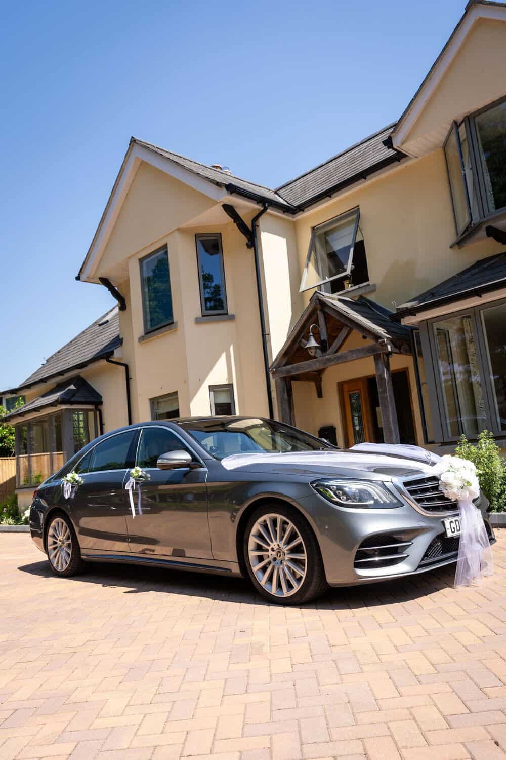 Luxury wedding car in front of a house by Southampton wedding photographer John Watson