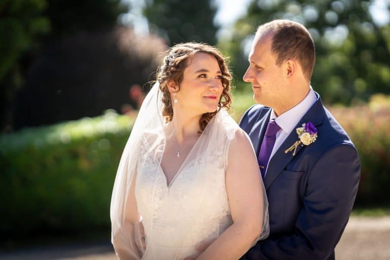 Bride and groom in garden setting by Southampton wedding photographer John Watson